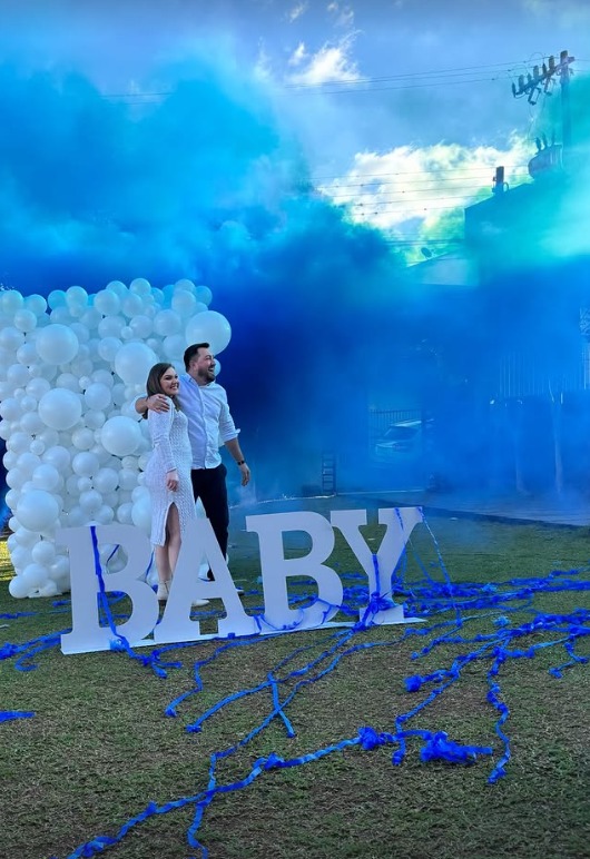 Chá revelação com fumaça azul no gramado